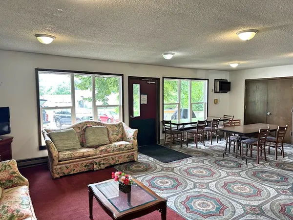 a living room with furniture and a large window