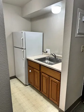 a utility room with cabinets washer and dryer
