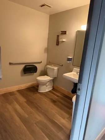 a bathroom with a toilet and a shower