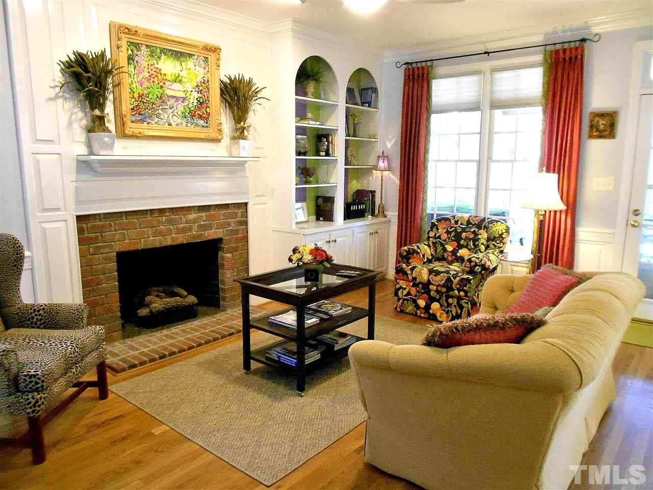 8704 Aldersgate Way Raleigh, NC 27615 - Photo 2 of 25 a living room with furniture and a fireplace