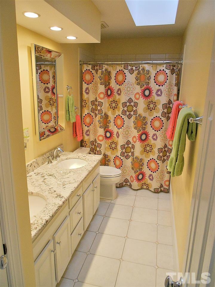 8704 Aldersgate Way Raleigh, NC 27615 - Photo 11 of 25 a bathroom with a granite countertop sink and a shower
