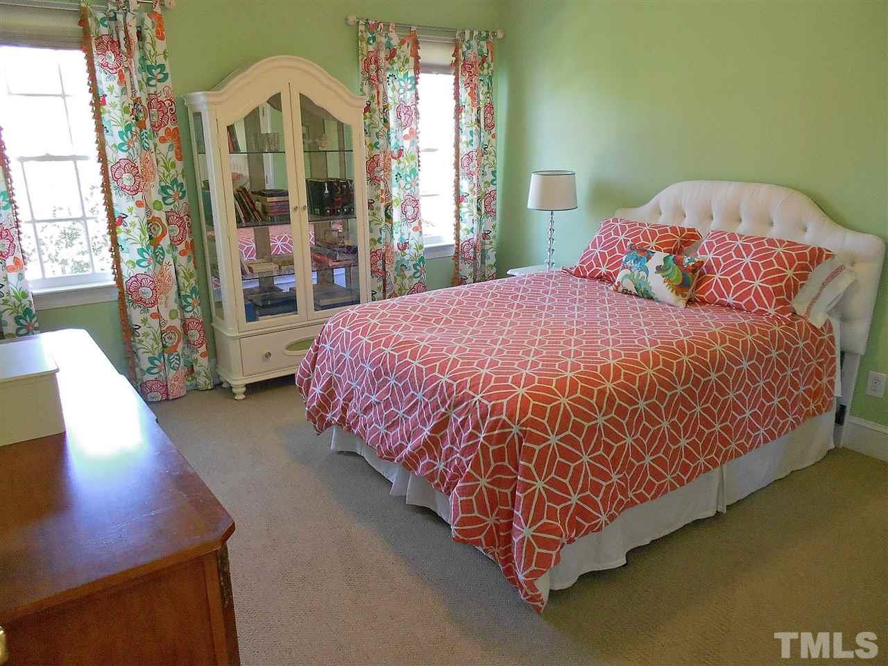 8704 Aldersgate Way Raleigh, NC 27615 - Photo 12 of 25 a bed sitting in a bedroom next to a large window