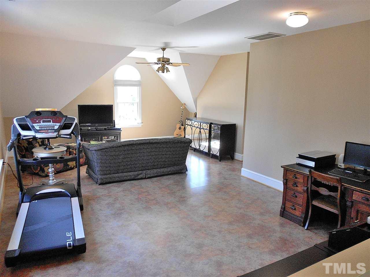 8704 Aldersgate Way Raleigh, NC 27615 - Photo 14 of 25 a living room with furniture and a flat screen tv