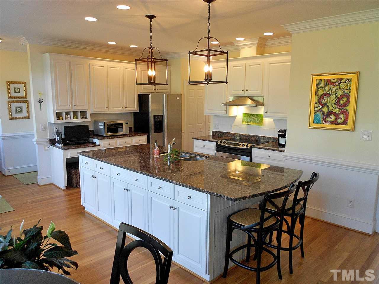 8704 Aldersgate Way Raleigh, NC 27615 - Photo 16 of 25 a kitchen with stainless steel appliances granite countertop a stove a sink and a refrigerator