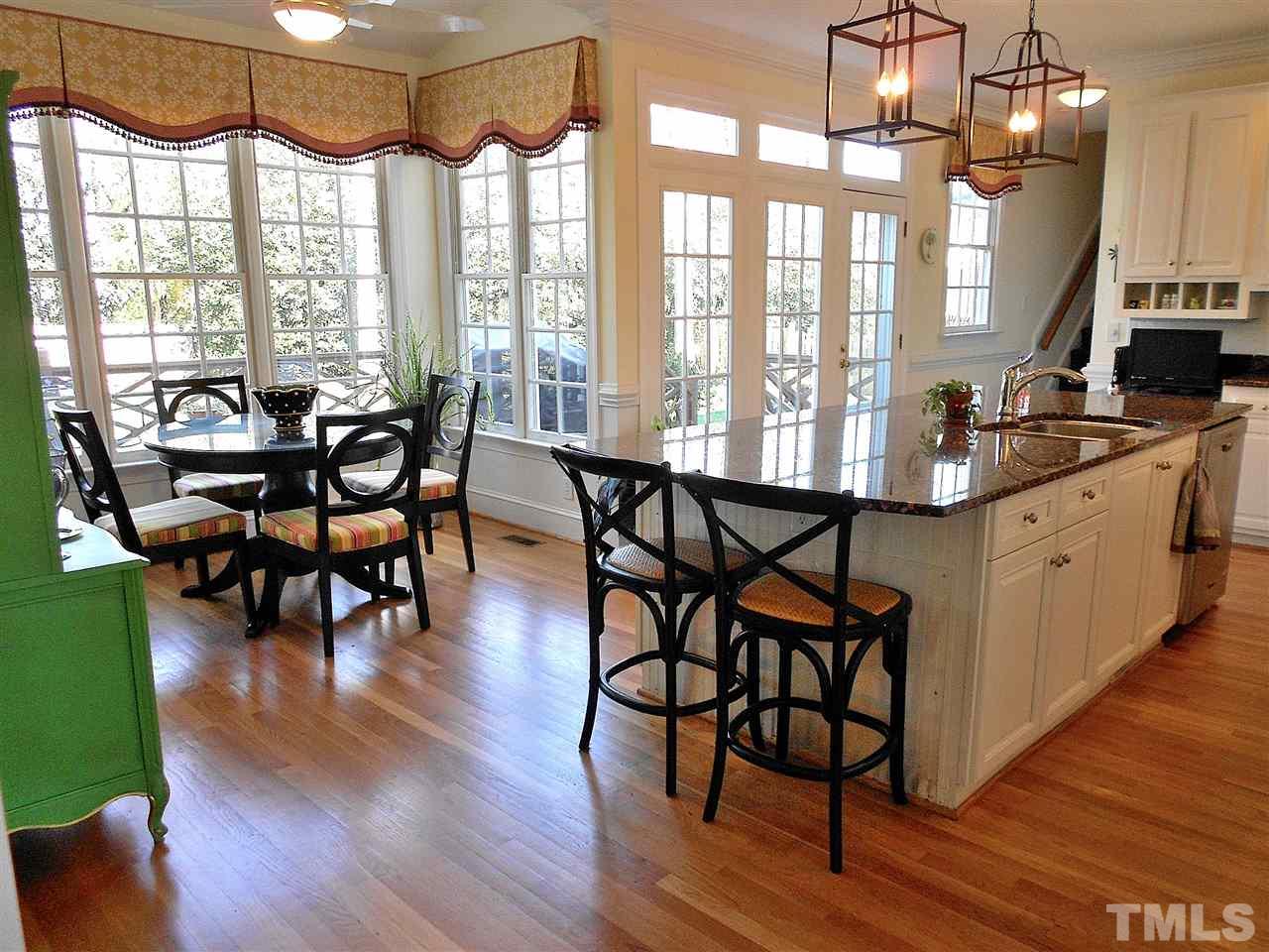 8704 Aldersgate Way Raleigh, NC 27615 - Photo 18 of 25 a view of a dining room with furniture window and wooden floor