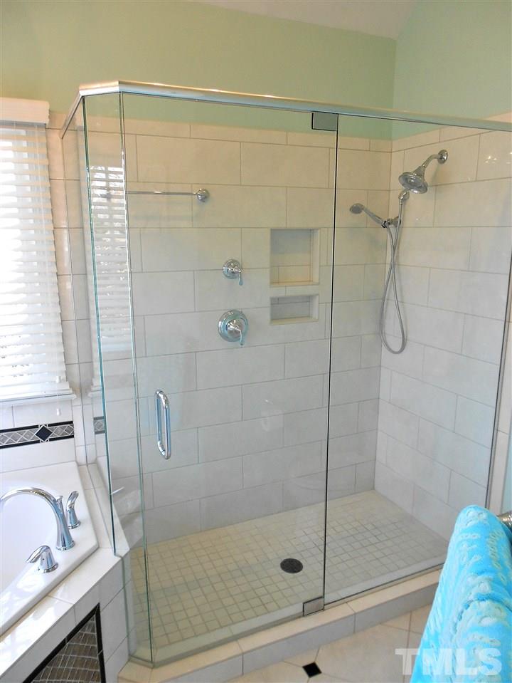 8704 Aldersgate Way Raleigh, NC 27615 - Photo 9 of 25 a bathroom with a shower and a sink