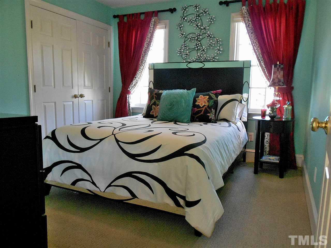 8704 Aldersgate Way Raleigh, NC 27615 - Photo 10 of 25 a bed sitting in a bedroom next to a window