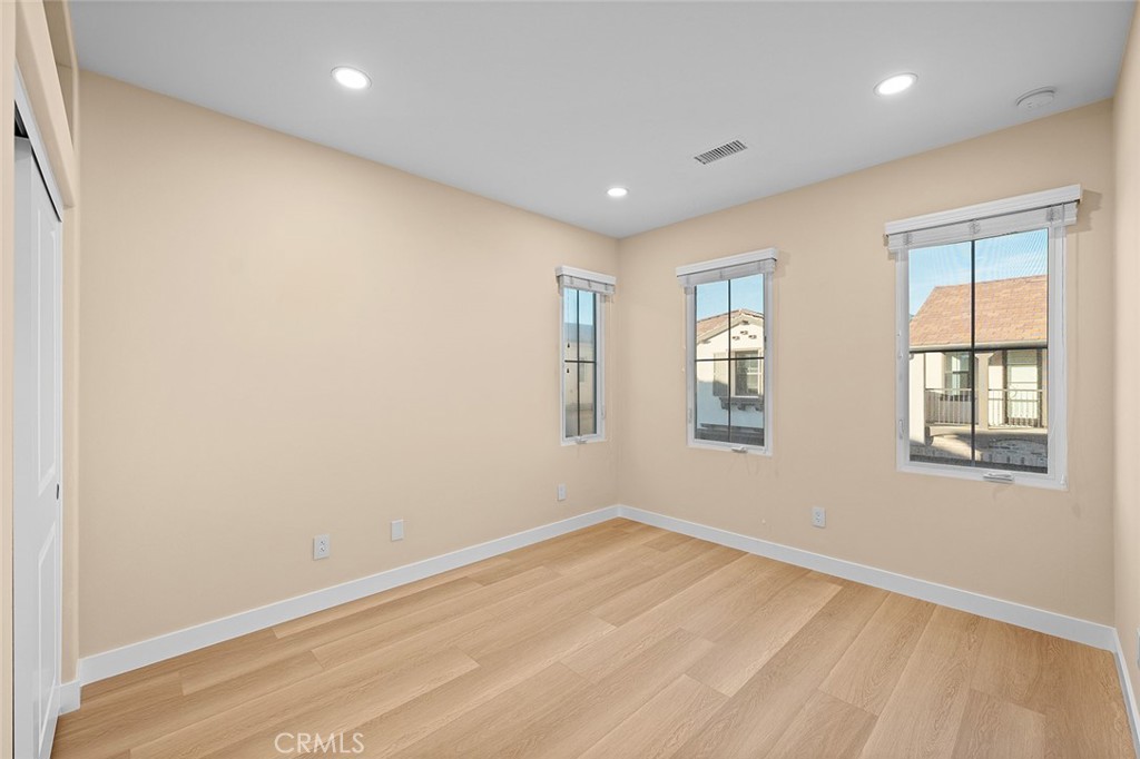 143 Rodeo Irvine, CA 92602 - Photo 29 of 37 a view of empty room with wooden floor and fan