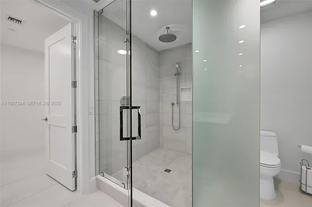 a dining room with furniture a large window and a chandelier