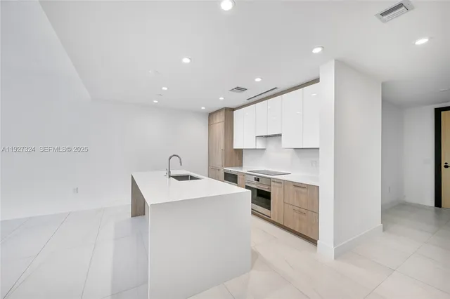 a bathroom with a granite countertop sink a mirror and a bathtub