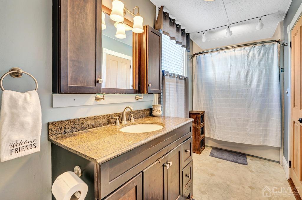 387 Prospect Avenue Dunellen, NJ 08812 - Photo 17 of 34 a bathroom with a sink and a mirror