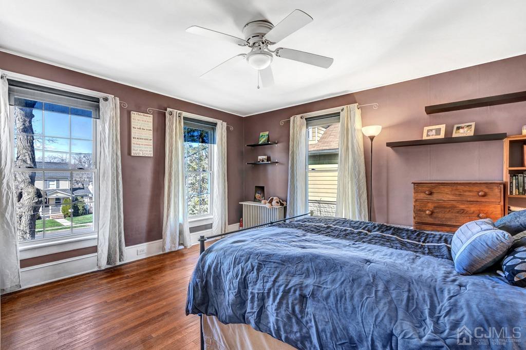 387 Prospect Avenue Dunellen, NJ 08812 - Photo 18 of 34 a bedroom with a bed and a fireplace