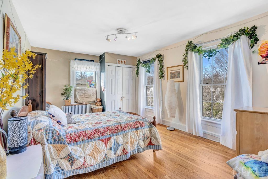 387 Prospect Avenue Dunellen, NJ 08812 - Photo 20 of 34 a bedroom with a bed table and a window