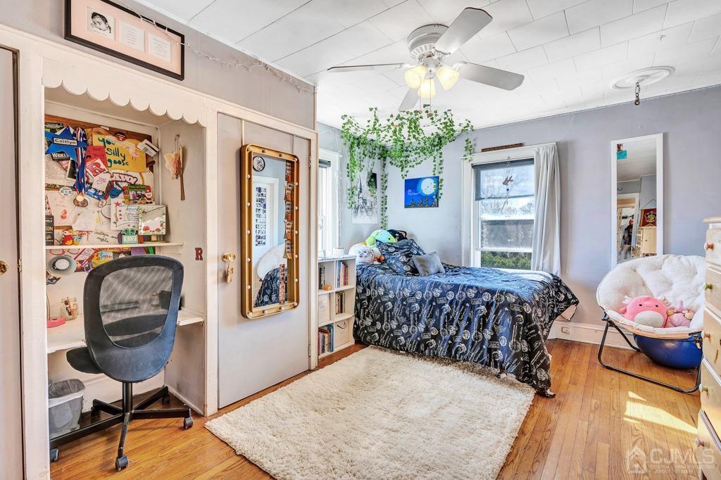 387 Prospect Avenue Dunellen, NJ 08812 - Photo 21 of 34 a bedroom with bed or couch and a chandelier