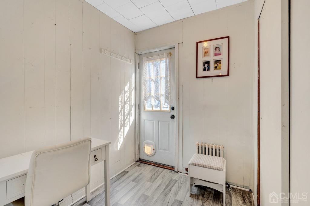387 Prospect Avenue Dunellen, NJ 08812 - Photo 25 of 34 a view of a hallway with wooden floor and furniture