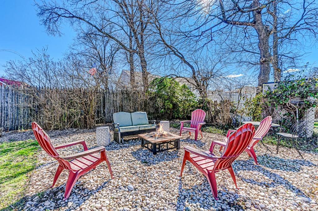 387 Prospect Avenue Dunellen, NJ 08812 - Photo 28 of 34 a view of a chairs and fire pit in the backyard of the house