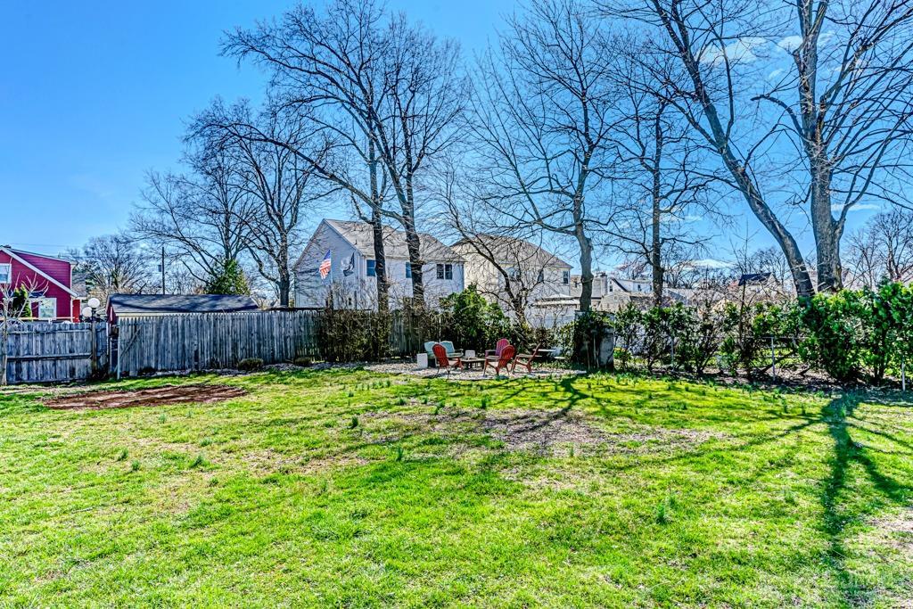 387 Prospect Avenue Dunellen, NJ 08812 - Photo 29 of 34 a view of backyard with wooden fence and trees