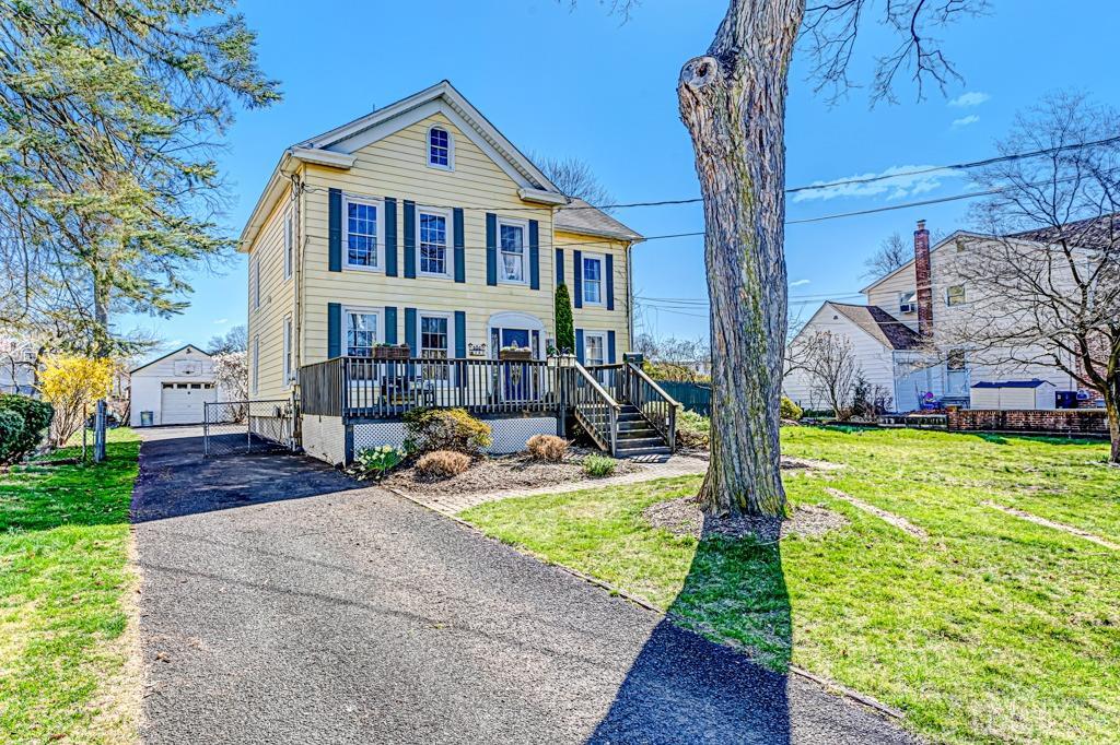 387 Prospect Avenue Dunellen, NJ 08812 - Photo 3 of 34 a front view of a house with garden