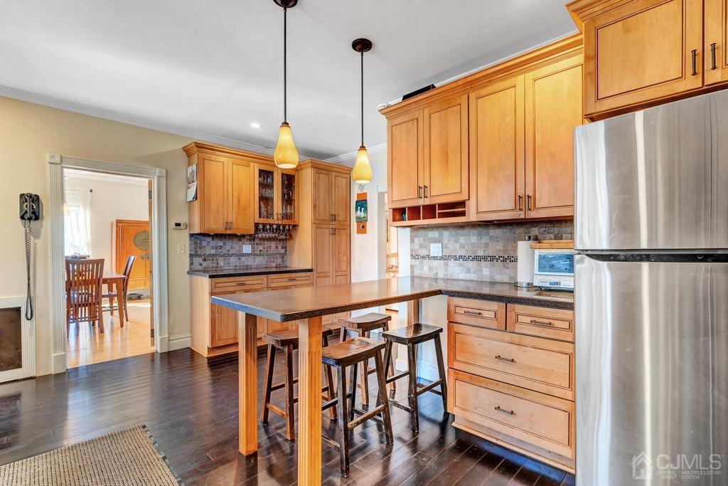 387 Prospect Avenue Dunellen, NJ 08812 - Photo 8 of 34 a kitchen with stainless steel appliances granite countertop a refrigerator a stove and a sink with cabinets