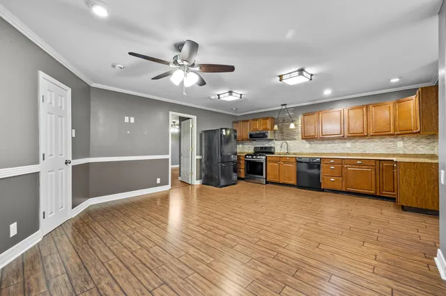 a view of kitchen with cabinets and wooden floor