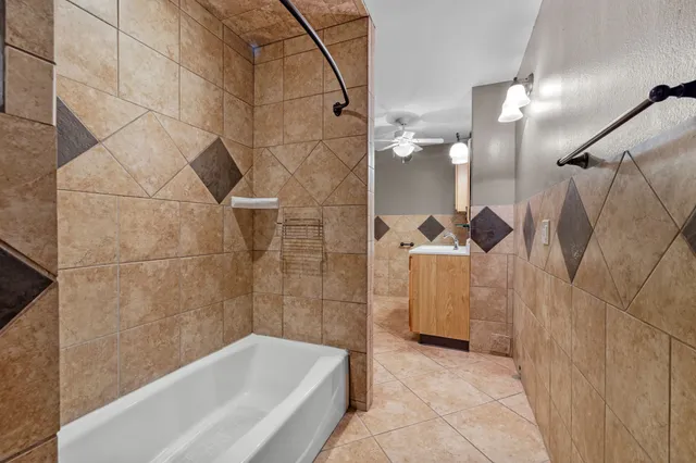 a bathroom with a bathtub and shower
