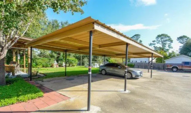 a view of a house with a yard patio and sitting area