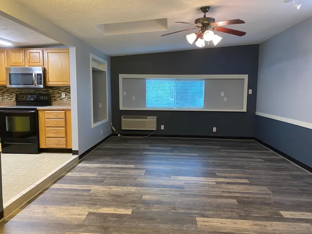 a view of kitchen center with microwave and stove