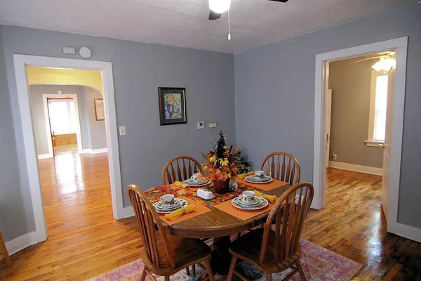a view of a dining room with furniture and wooden floor
