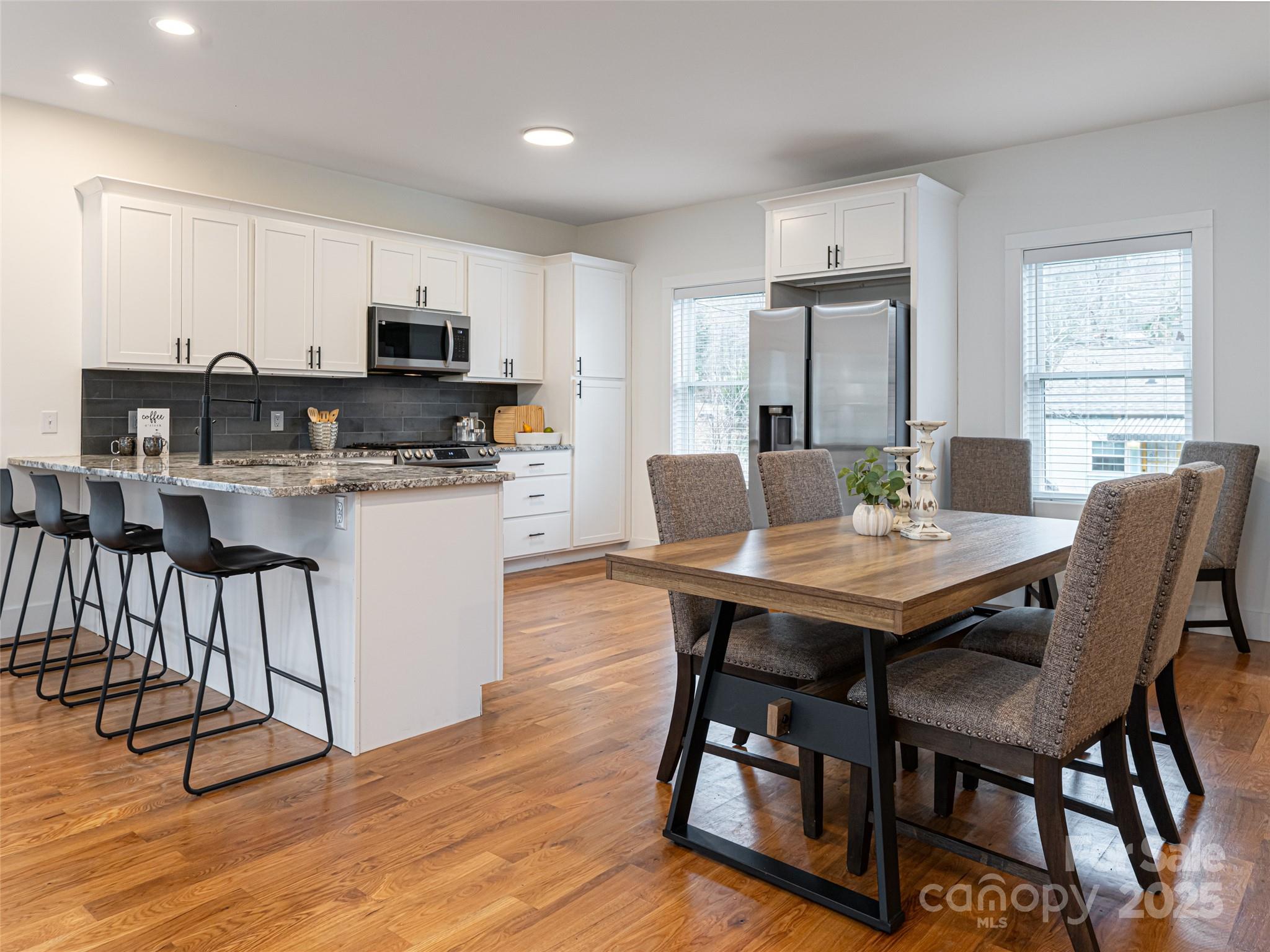 197 Chatham Road Asheville, NC 28804 - Photo 14 of 46 a view of a dining room with furniture and wooden floor