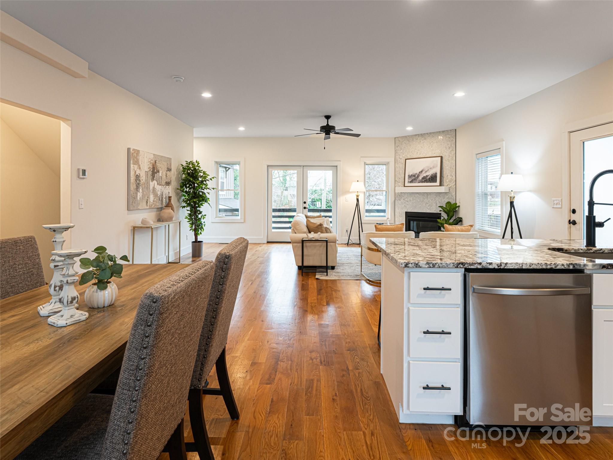 197 Chatham Road Asheville, NC 28804 - Photo 22 of 46 a open dining room with kitchen island granite countertop wooden floor and a refrigerator