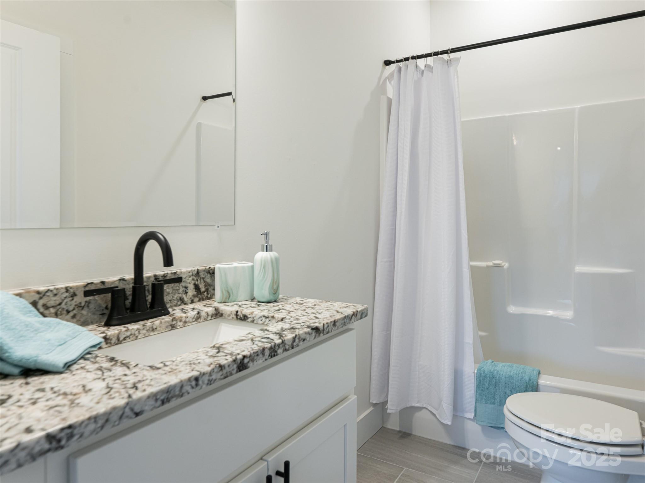 197 Chatham Road Asheville, NC 28804 - Photo 30 of 46 a bathroom with a granite countertop sink and a mirror