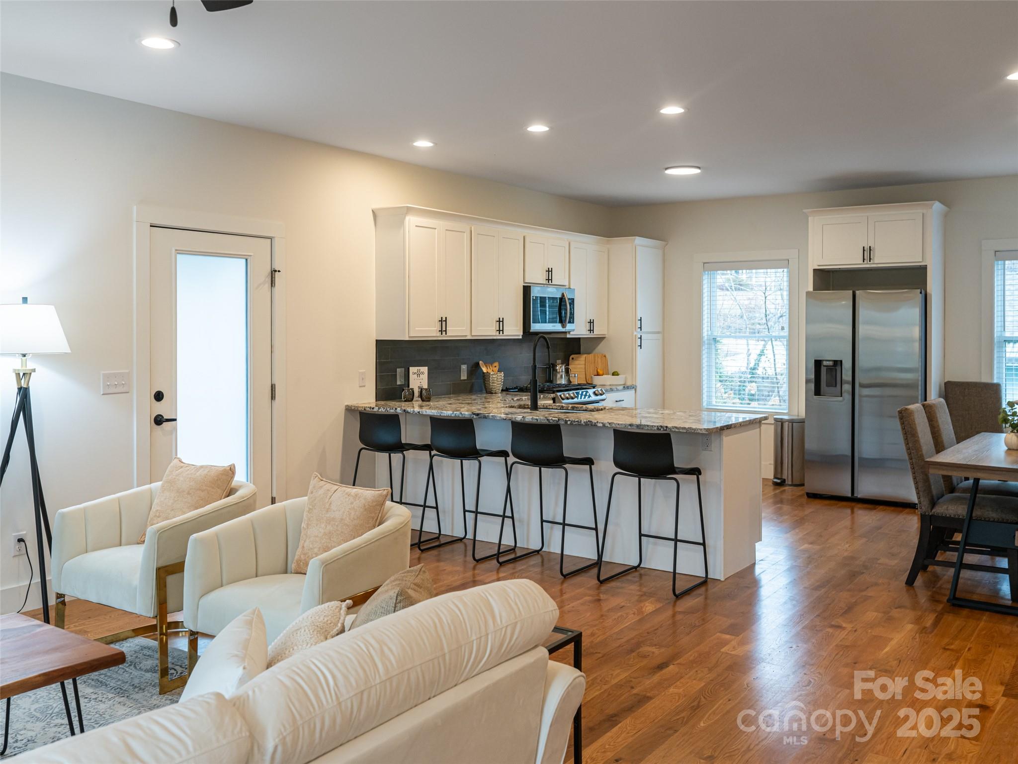 197 Chatham Road Asheville, NC 28804 - Photo 9 of 46 a living room with furniture and a dining table with kitchen view