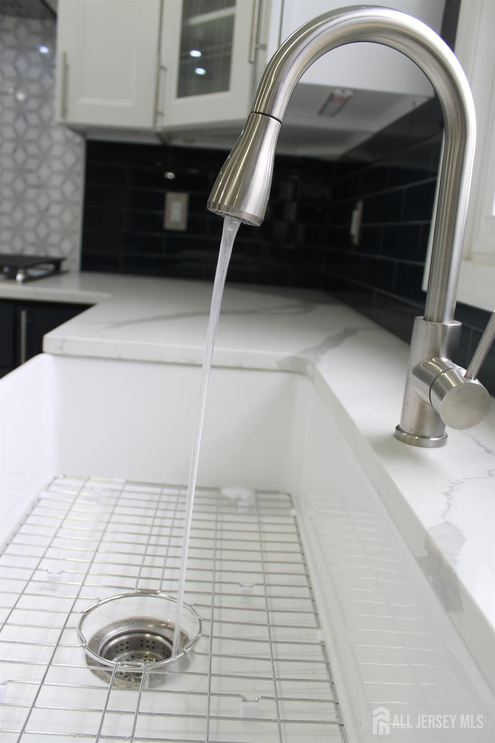 1 Sussex Road East Brunswick, NJ 08816 - Photo 12 of 60 a bathroom with a sink and a mirror