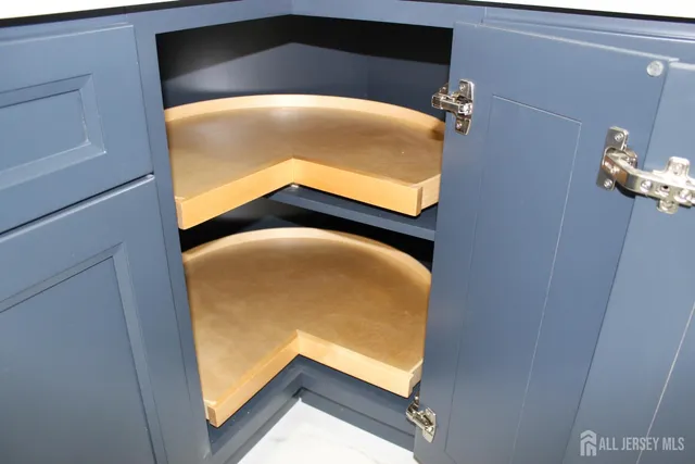 a view of an empty room with wooden floor fire place