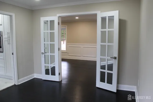a view of staircase with white walls and white door