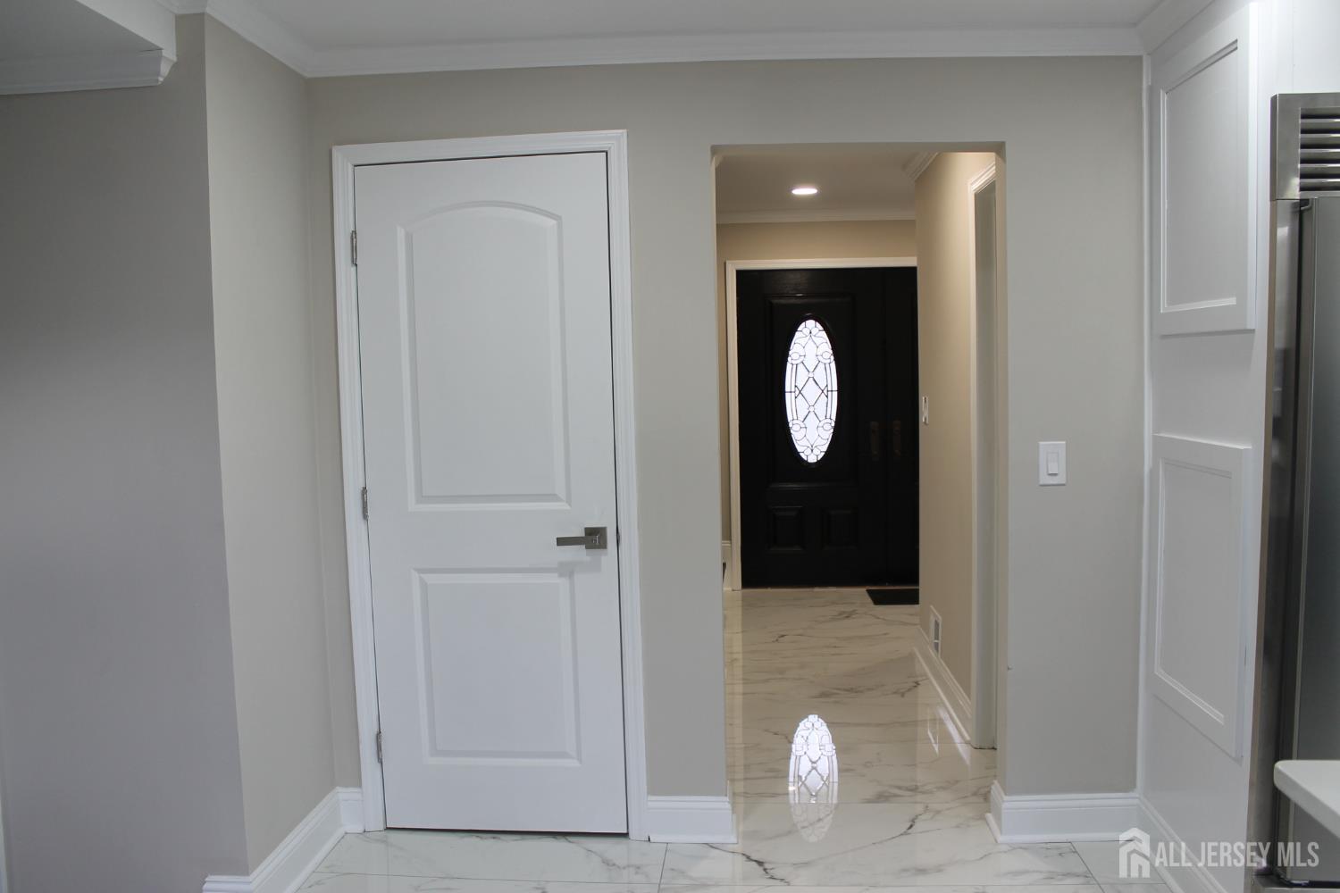 1 Sussex Road East Brunswick, NJ 08816 - Photo 25 of 60 a view of a hallway with wooden floor and glass door