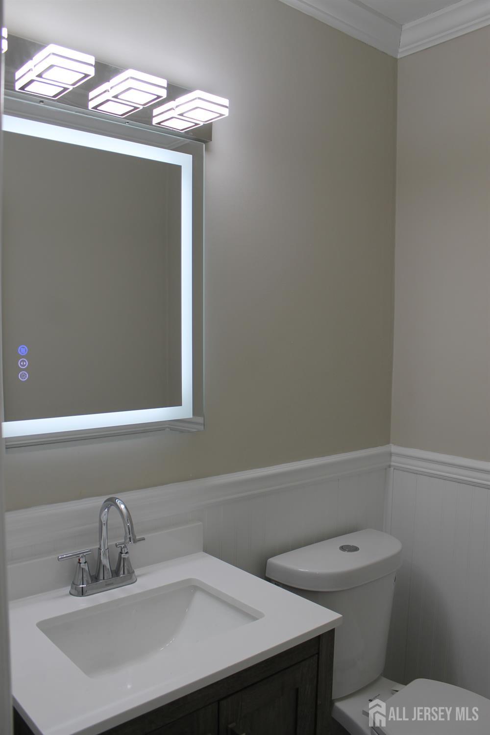 1 Sussex Road East Brunswick, NJ 08816 - Photo 30 of 60 a bathroom with a sink a toilet and a mirror