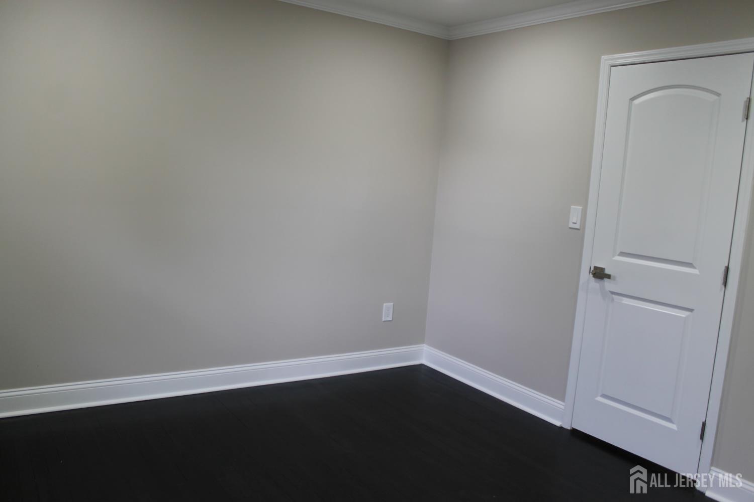 1 Sussex Road East Brunswick, NJ 08816 - Photo 36 of 60 an empty room with wooden floor and closet