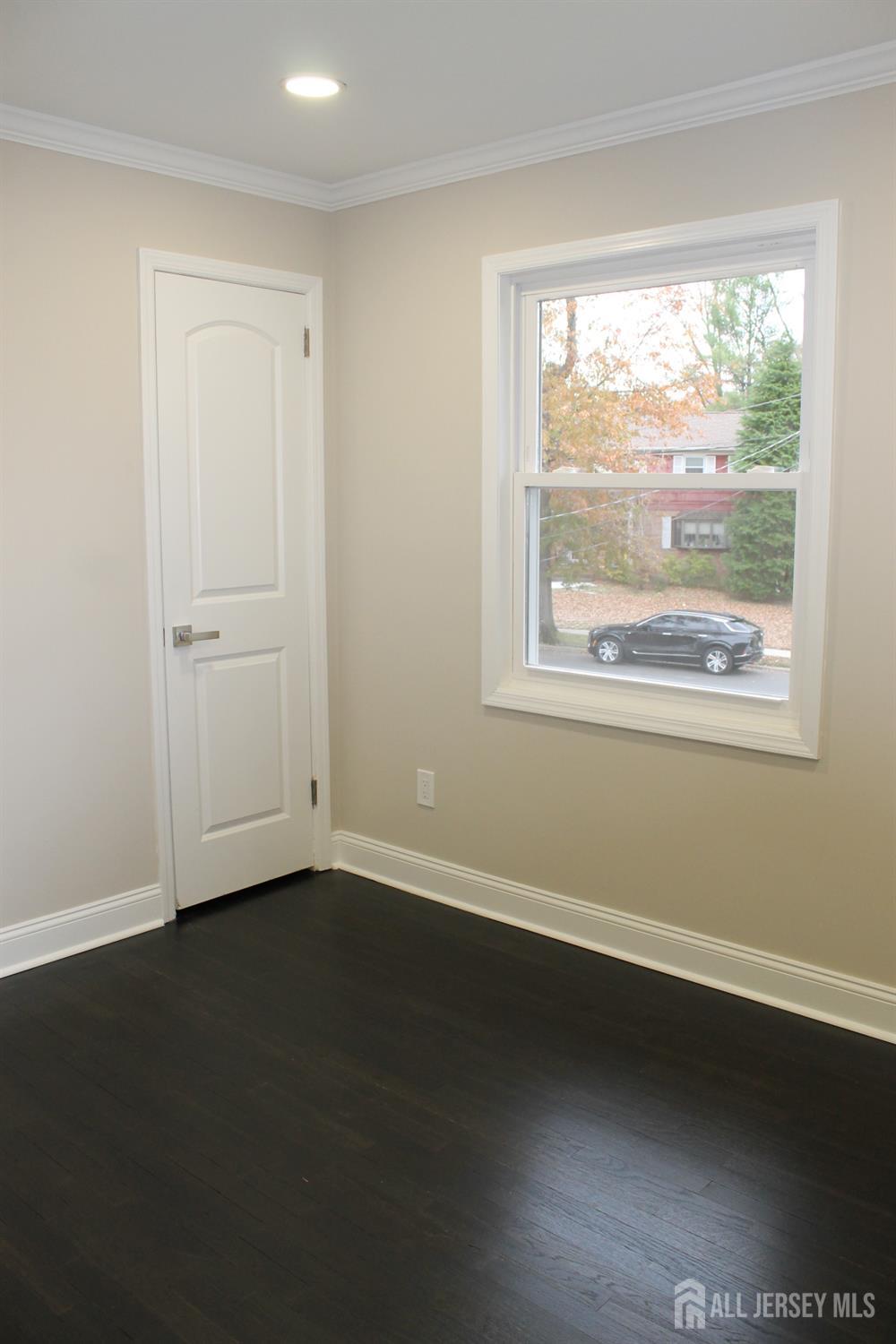 1 Sussex Road East Brunswick, NJ 08816 - Photo 40 of 60 an empty room with wooden floor and windows