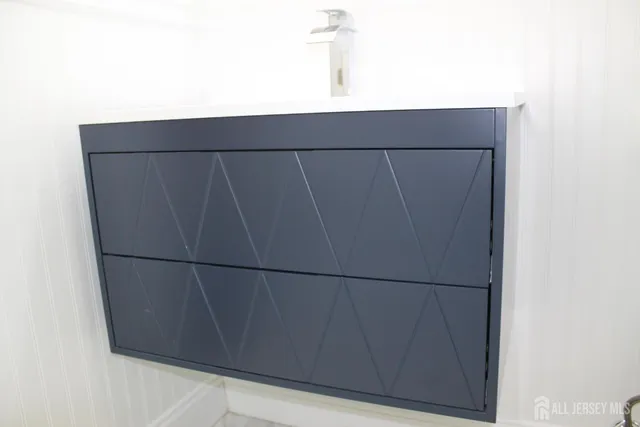 a bathroom with a sink vanity and a mirror