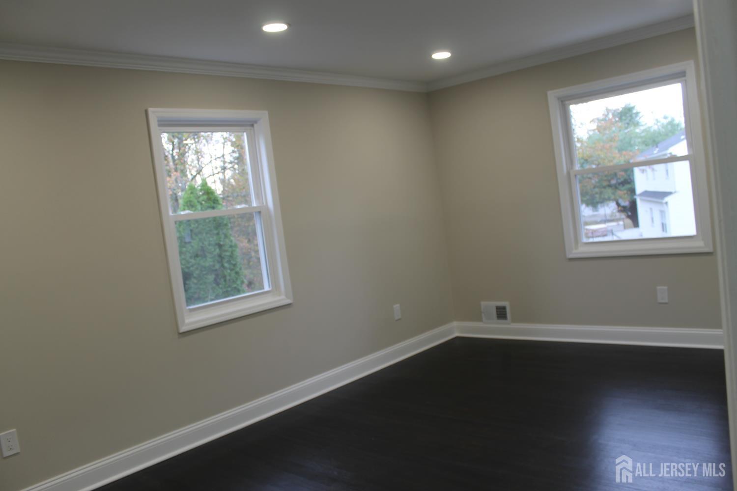 1 Sussex Road East Brunswick, NJ 08816 - Photo 44 of 60 an empty room with wooden floor and windows