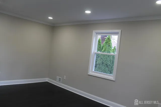 an empty room with wooden floor