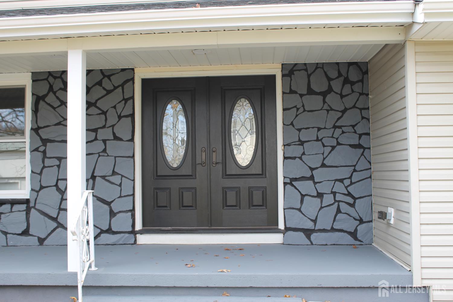 1 Sussex Road East Brunswick, NJ 08816 - Photo 5 of 60 a front view of a house with a bench