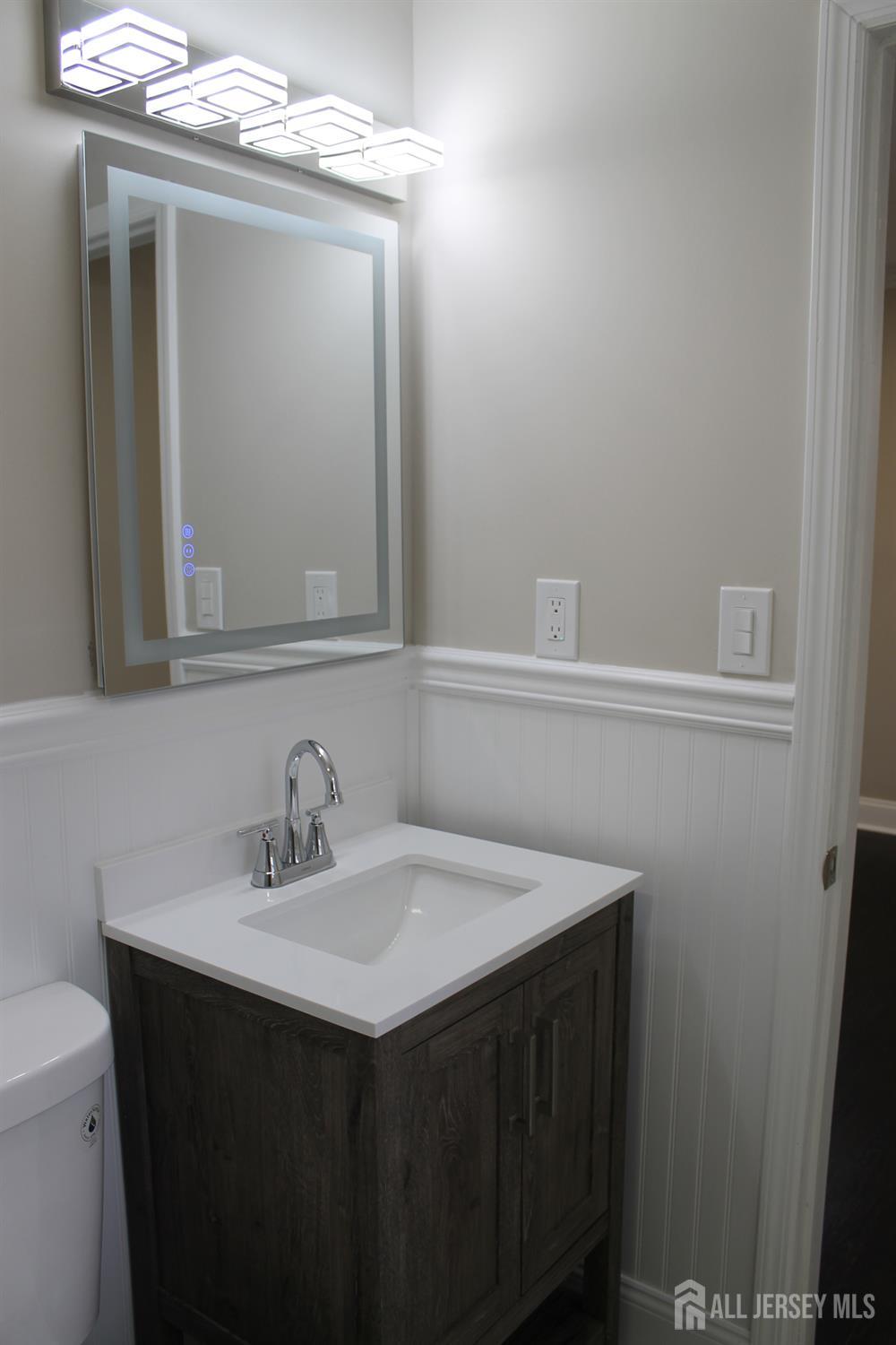 1 Sussex Road East Brunswick, NJ 08816 - Photo 51 of 60 a bathroom with a sink vanity and a mirror