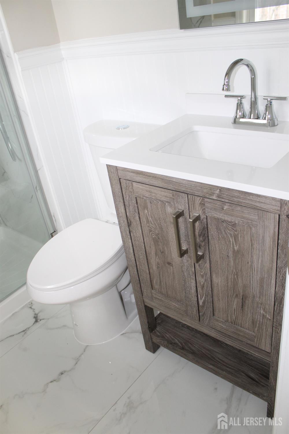 1 Sussex Road East Brunswick, NJ 08816 - Photo 52 of 60 a bathroom with a toilet and sink