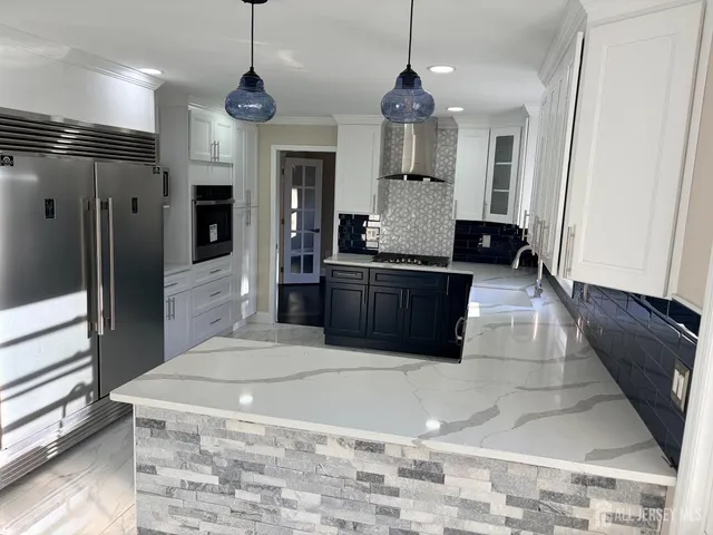 a kitchen with granite countertop a sink and a stove