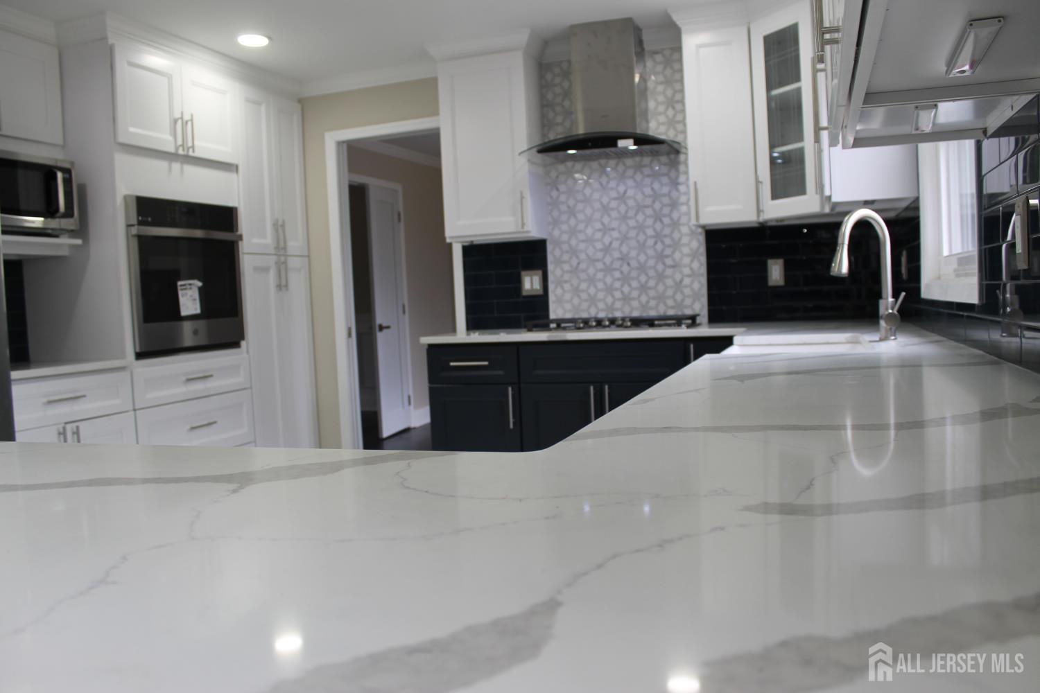 1 Sussex Road East Brunswick, NJ 08816 - Photo 8 of 60 a kitchen with stainless steel appliances kitchen island granite countertop a refrigerator a oven a sink and a stove