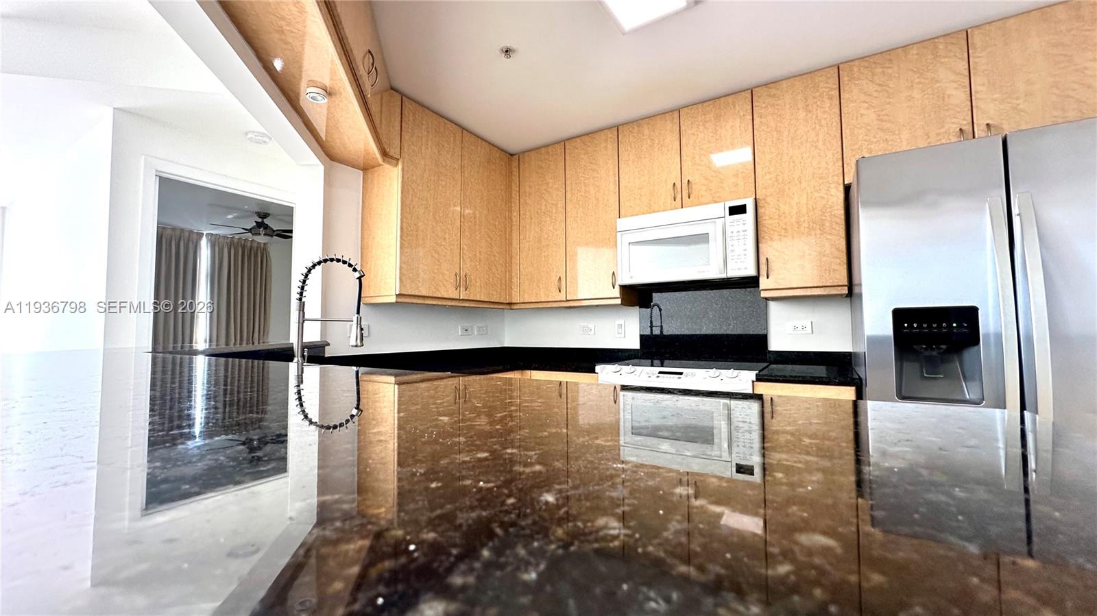 801 Brickell Key Boulevard, Unit 2707 Miami, FL 33131 - Photo 15 of 26 a kitchen with stainless steel appliances a refrigerator sink and microwave