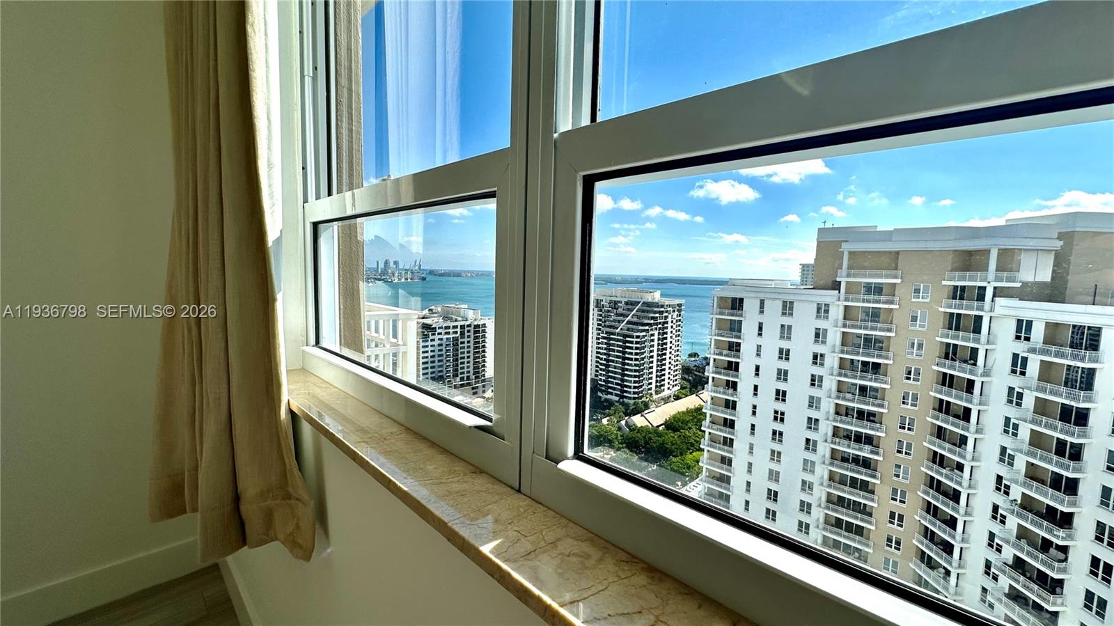 801 Brickell Key Boulevard, Unit 2707 Miami, FL 33131 - Photo 17 of 24 a view of a balcony with chairs