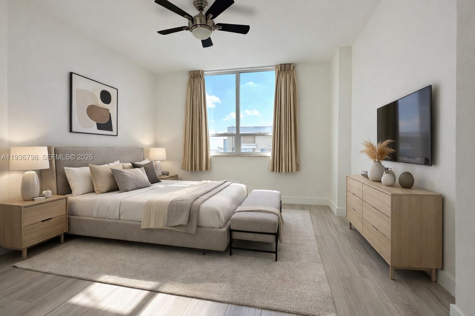 801 Brickell Key Boulevard, Unit 2707 Miami, FL 33131 - Photo 5 of 24 a bedroom with a bed and a flat screen tv